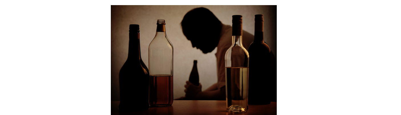 Man holding a bottle and surrounded by bottles